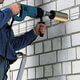 A 152mm Dry Diamond Core Drill being used to drill a hole in a wall.
