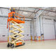 A JLG 3246ES 11.68m Electric Scissor Lift being used in a warehouse.